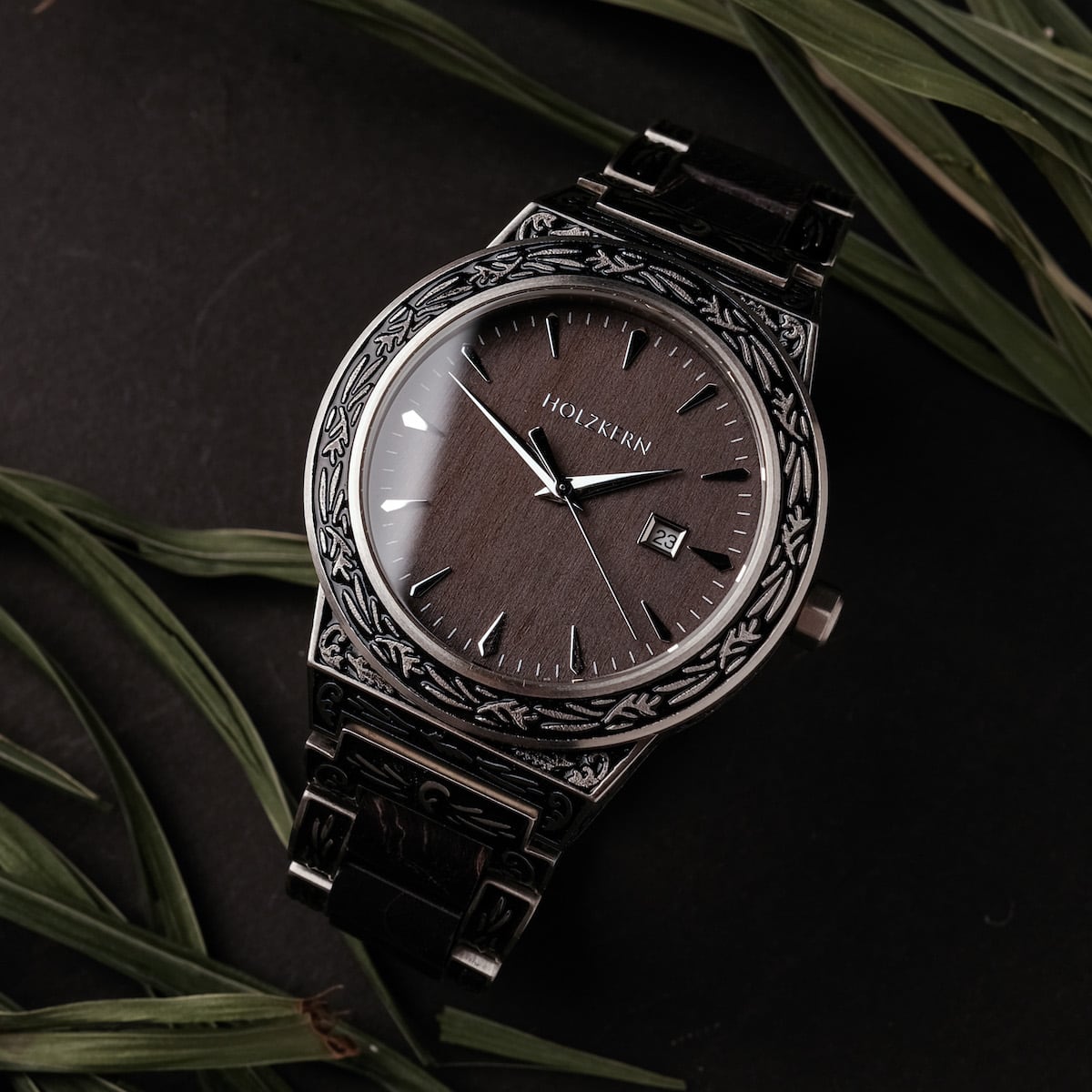 "Misir" watch with intricate engravings and maple finish, featuring a dark elegant dial.