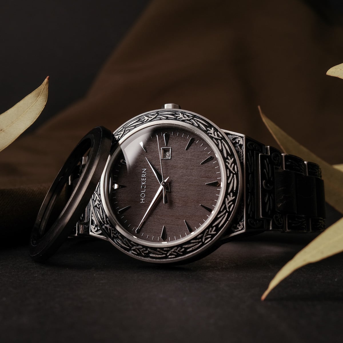 "Misir" watch with intricate silver detailing and a dark maple finish, highlighting its elegant and sophisticated design.