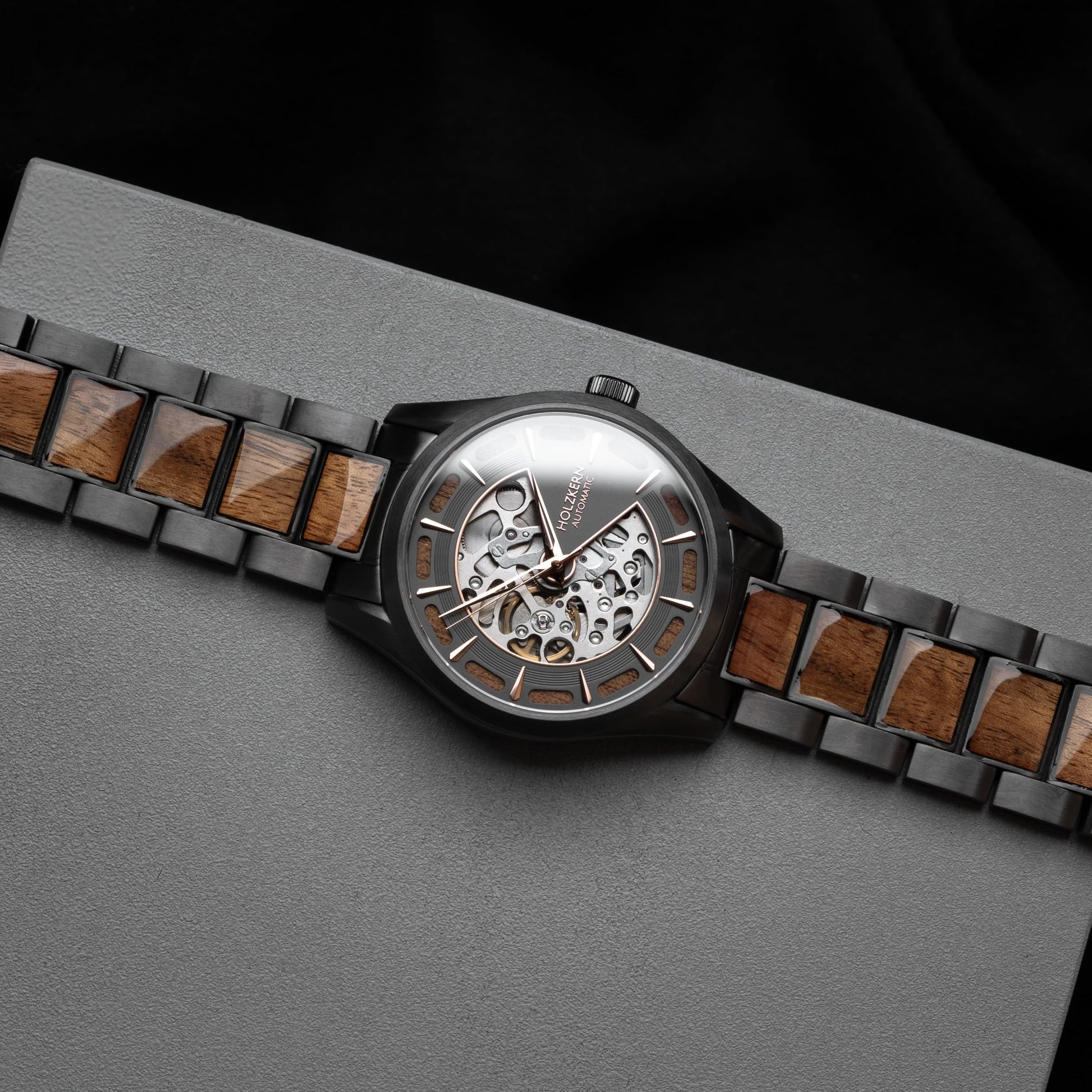 "Tenoumer" watch featuring a Koa and dark gray design with a distinctive skeletal dial.
