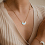 "Hue Necklace": Elegant crescent necklace in blue nacre with rose gold accents.