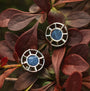 "Amulet Earrings" features elegant marble and silver earrings with a circular, geometric design.