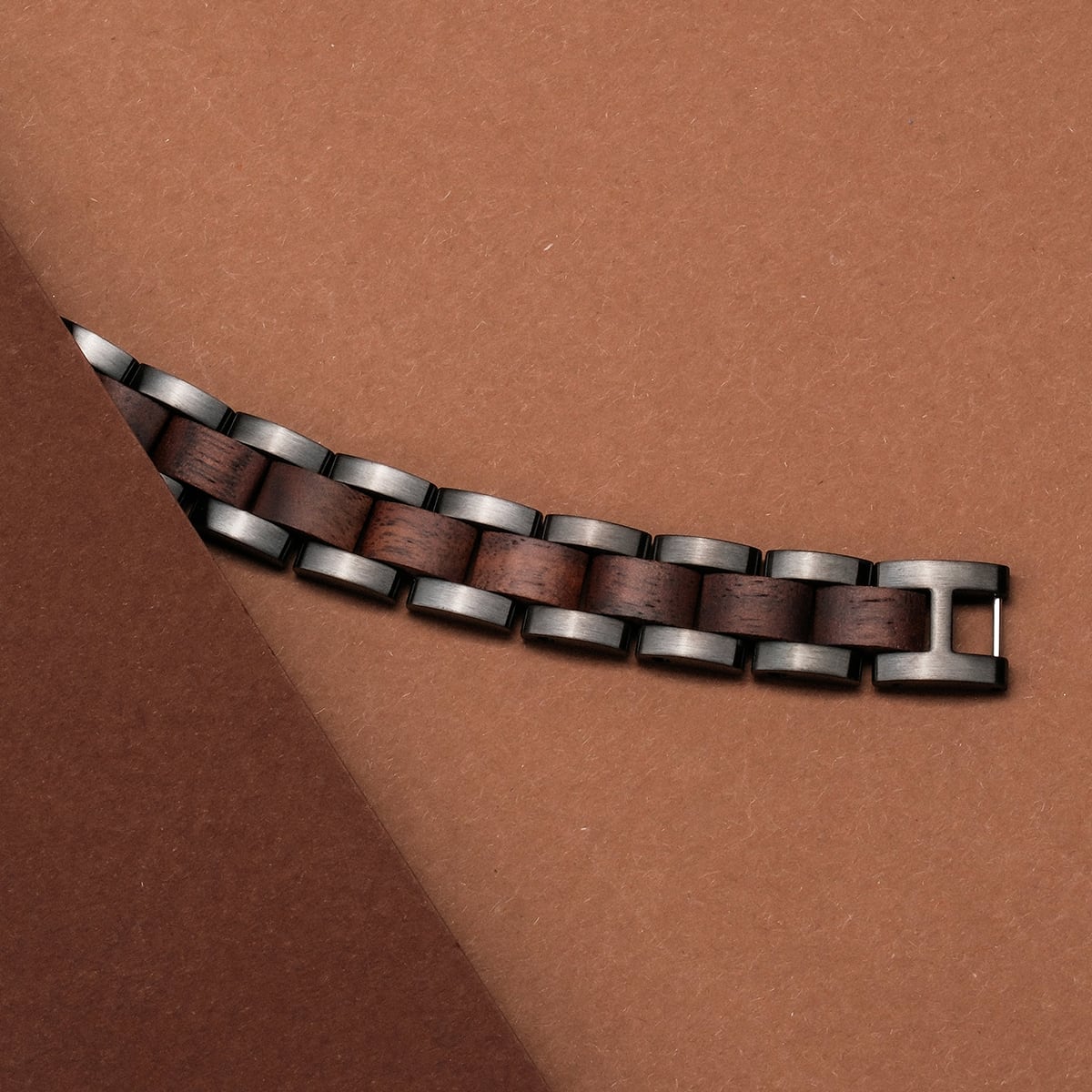 "Triad" watch strap in Walnut and Gray, showcasing a sleek, modern design with rich wood accents.