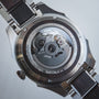 "Will" watch displaying a sleek, metallic design with intricate internal mechanics visible through the back.