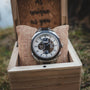 "Will" watch in a wooden box, featuring a modern design with metal accents and natural aesthetics.