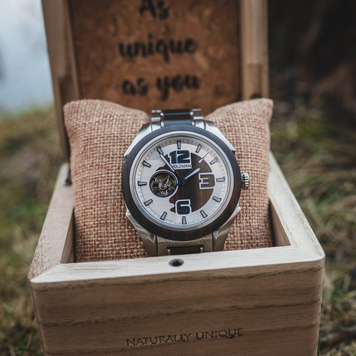 "Will" watch in a wooden box, featuring a modern design with metal accents and natural aesthetics.